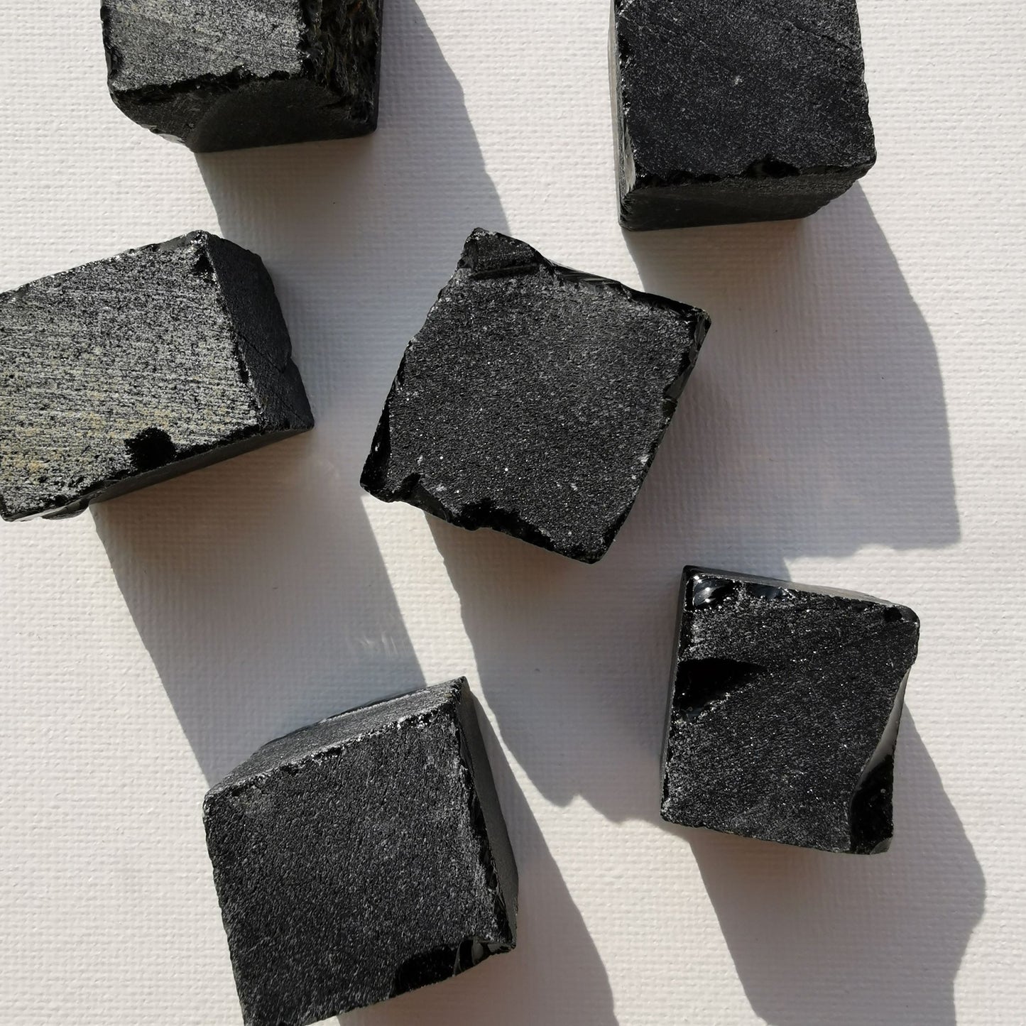 Dumi's Crystals | Square Rough Black Obsidian Crystals (Balance & Growth) | A collection of Square Rough Black Obsidian Crystals, reminders of your inner strength. Black Obsidian protects, grounds & promotes self-discovery. Scatter them in your home or workspace to create a safe and balanced environment, welcome emotional healing & growth. Embrace the power of Black Obsidian from Dumi's Crystals!