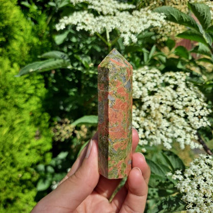 Dumi's Crystals | Unakite Tower (8-10cm) | A close-up view of a captivating Unakite Tower (8-10cm), showcasing its unique blend of green and pink hues. This crystal is believed to promote emotional balance, inner peace, and spiritual growth.