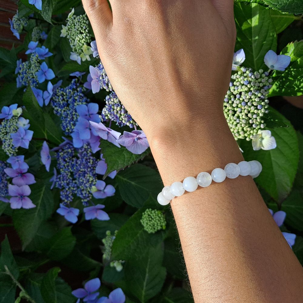 Dumi's Crystals | White Jade Stretch Bracelet (7 Inch with 8mm Beads) | Showcasing the captivating beauty of 8mm White Jade beads on a wrist. This bracelet promotes inner peace, clarity, spiritual growth, and emotional balance. White Jade, the stone of peace and tranquility, is known for its luminous glow.
