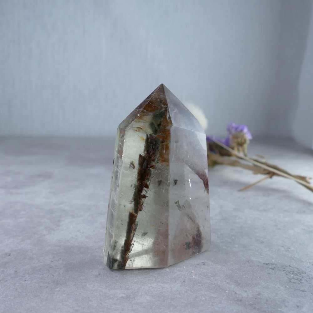 Nature's Art in Crystal Form - Dumi's Crystals (5.2cm). Explore the lush green inclusions within this Garden Quartz tower.