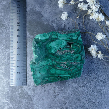 Unleash Malachite's Power! Dumi's Crystals Slab (8cm x 8.5cm x 1cm). Polished & natural malachite. Vibrant green & raw beauty promote emotional well-being, protection, and spiritual awakening. 