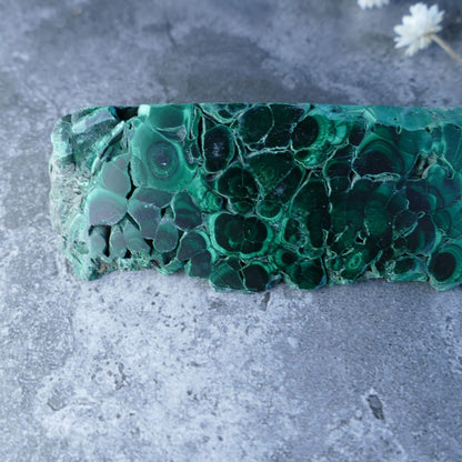 Embrace Change with Dumi's Crystals Malachite Prism (11.5cm, 3cm x 4.5cm x 3cm base). Unpolished malachite reveals raw beauty within a geometric form. Promotes healing, protection, and spiritual growth. 