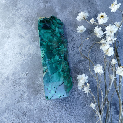 Dumi's Crystals - Malachite Transformation Prism (11.5cm, 3cm x 4.5cm x 3cm base). Striking geometry meets captivating green malachite! Unpolished edges reveal raw beauty for healing, protection, and spiritual growth.  