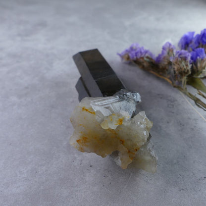 Dumi's Crystals - Irradiated Smoky Quartz Cluster (83g). Unique elongated shape (2.7cm x 9.5cm x 2cm). Deep smoky hues with amplified energy for healing practices.