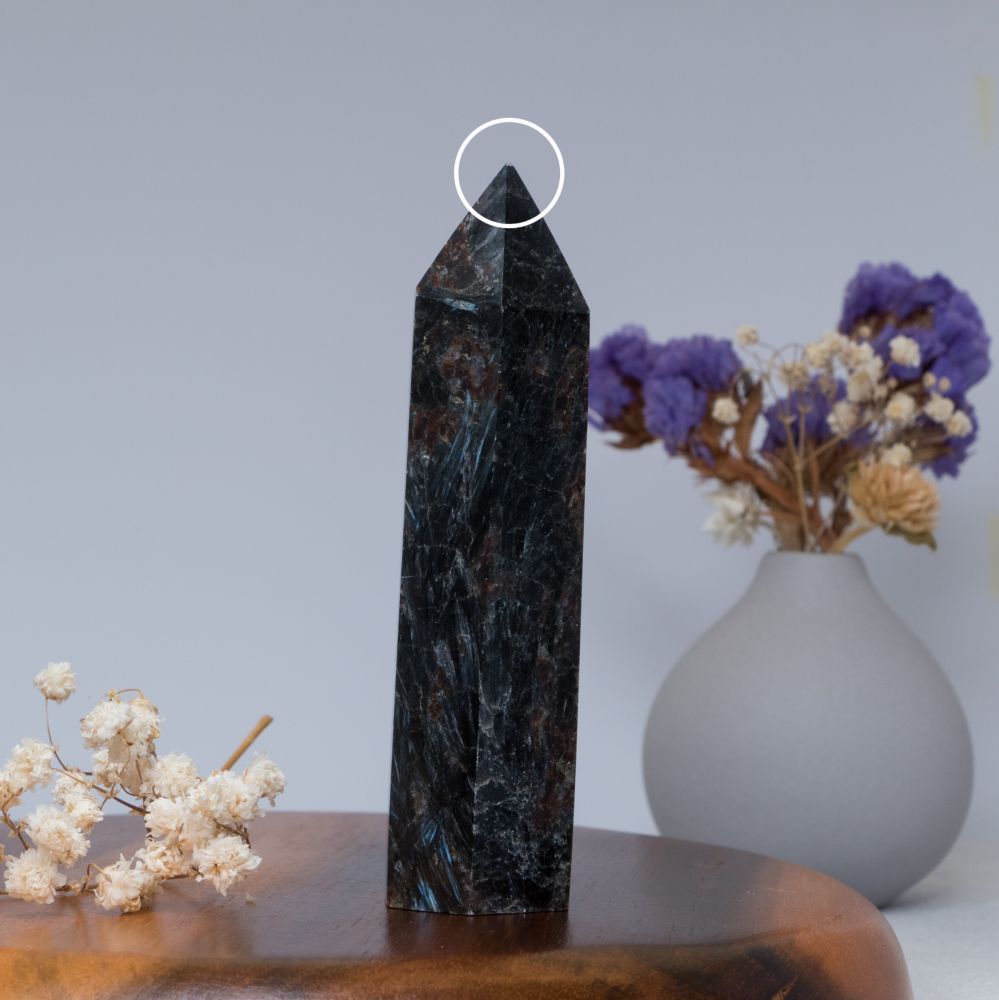 Arfvedsonite tower on wooden plate

