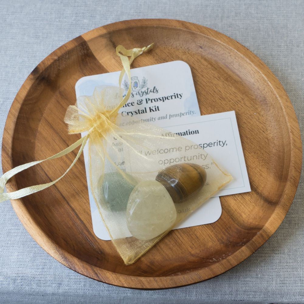 Crystal kit with stones and cards on a wooden plate