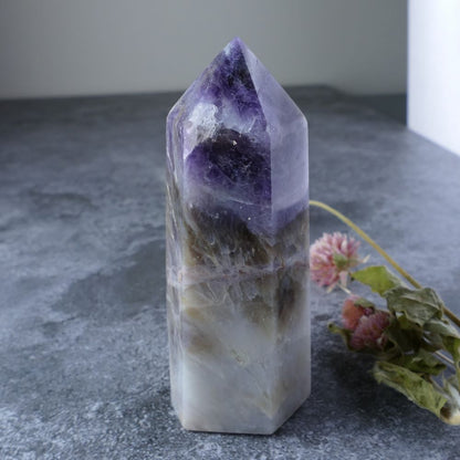 A captivating blend! This Amethyst, White Quartz, and Smoky Quartz tower fosters spiritual growth and inner strength.