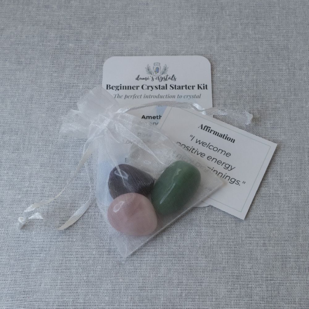 Beginner Crystal Starter Kit with stones and cards on a textured surface