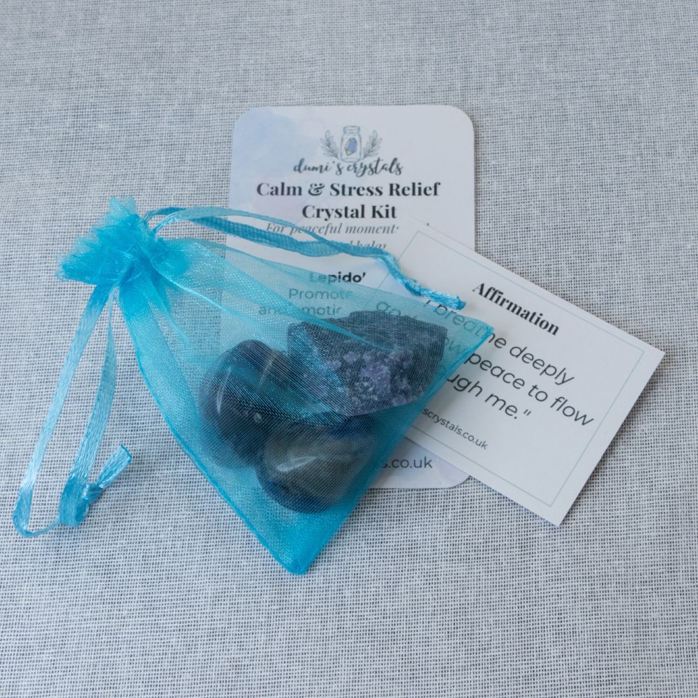 Crystal kit with stones and packaging on a textured surface