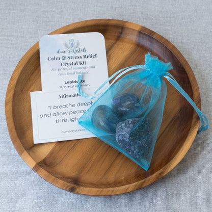Crystal kit for calm and stress relief on a wooden plate with a gray background
