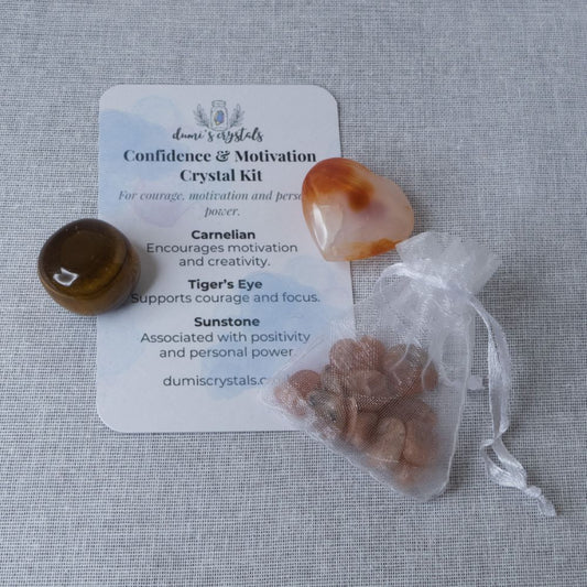 Crystal kit with carnelian, tiger's eye and sunstone and a card on a white background