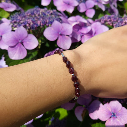 image of a bracelet made with garnet nuggets and silver plated beads. this bracelet is available at dumi's crystals