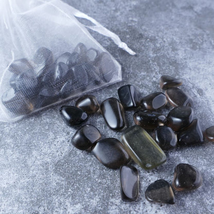 Dumi's Crystals | Ice Obsidian Chips (1-2cm) | Close-up of a collection of genuine Ice Obsidian chips, highlighting their distinctive icy sheen and variations in size and texture. Ice Obsidian is revered for its ability to shield against negativity, promote inner strength, and foster spiritual growth.
