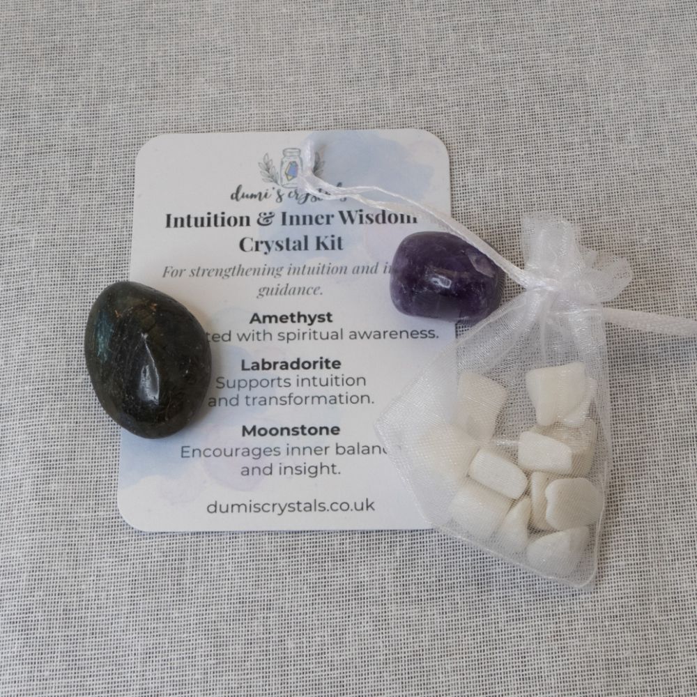 amethyst, labradorite, moonstone and a card on a white textured background