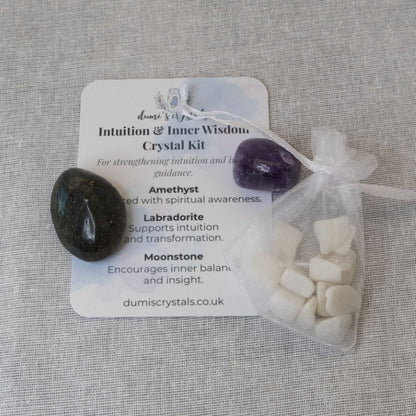 amethyst, labradorite, moonstone and a card on a white textured background
