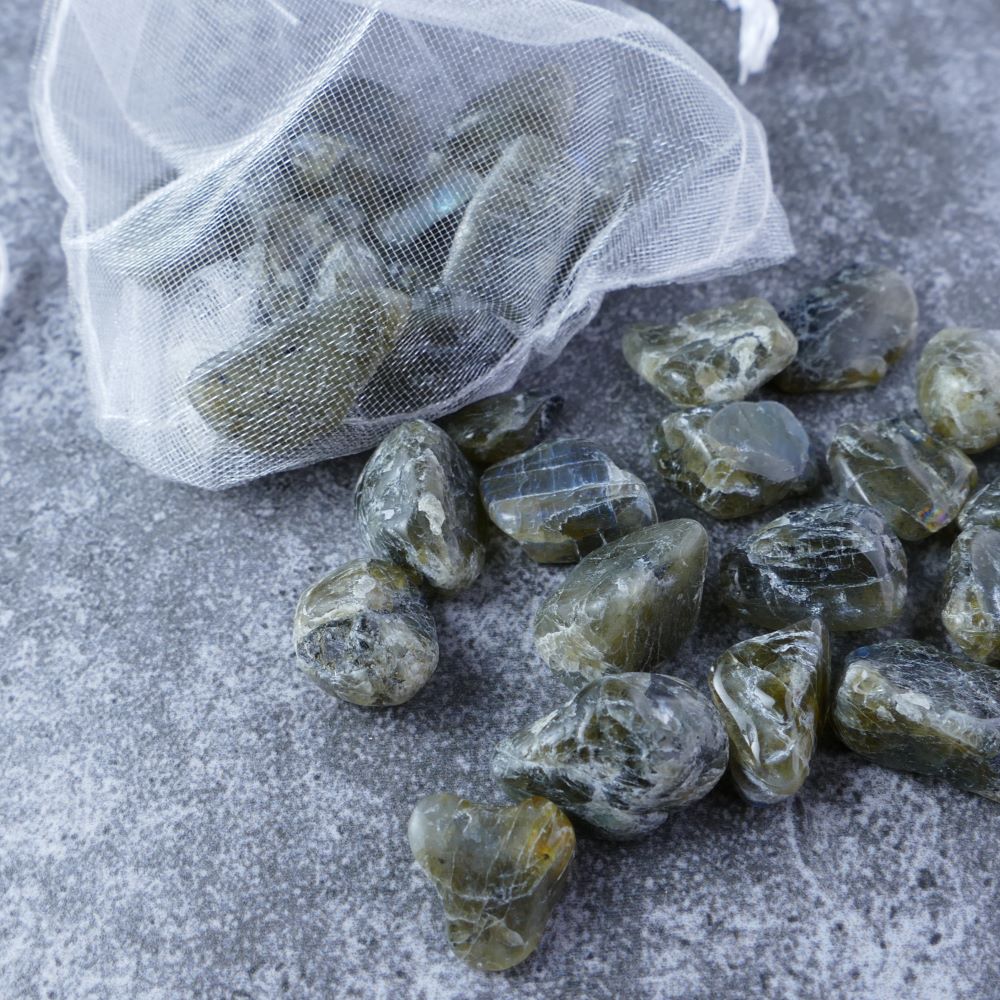 Dumi's Crystals | Labradorite Chips (1-2cm) | Close-up of a collection of genuine Labradorite chips, highlighting their mesmerizing iridescence with variations in blue and green hues. Labradorite is revered for its ability to promote transformation, intuition, and spiritual awakening.