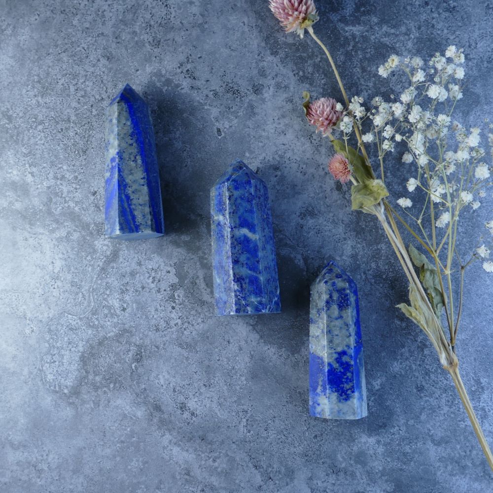 Lapis Lazuli Point Tower - This elegant Lapis Lazuli tower boasts a pointed tip and deep blue color with pyrite inclusions. Enhances intuition, strengthens willpower, and promotes self-expression. 