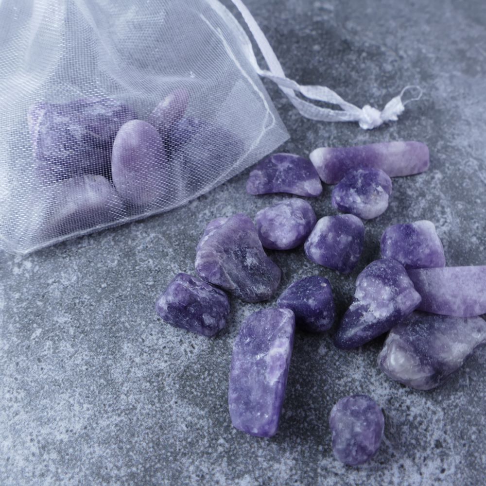 Dumi's Crystals | Lepidolite Chips (1-2.5cm) | Close-up of a collection of genuine Lepidolite chips, highlighting their captivating lilac color and variations in texture. Lepidolite is revered for its ability to promote emotional balance, peace, and emotional support.
