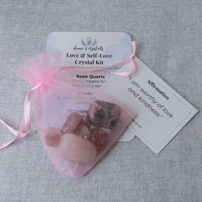 Crystal kit with rose quartz stones in a pink drawstring bag on a gray fabric background
