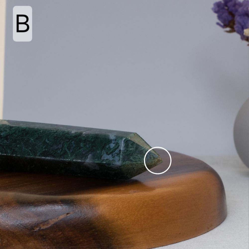 moss agate tower on wooden base against a light gray background