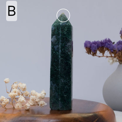 moss agate tower  on a wooden surface with a blurred background