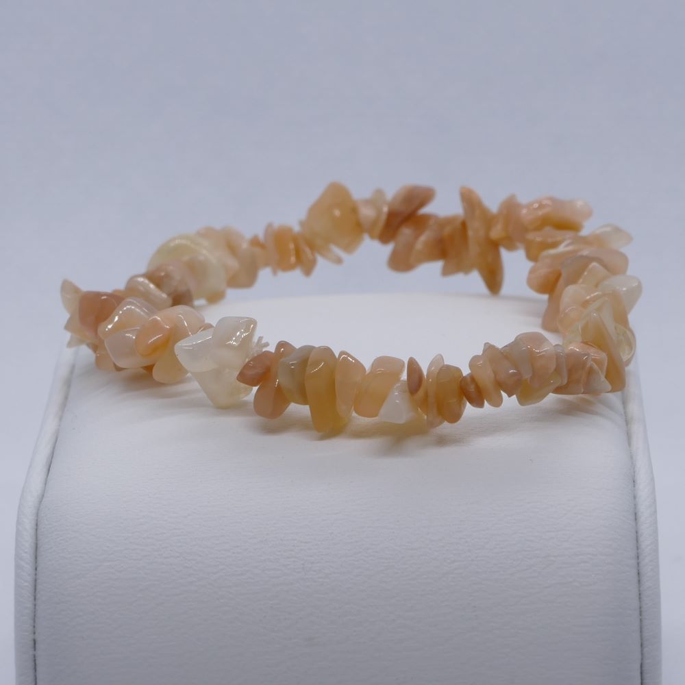 Dumi's Crystals | Peach Moonstone Stretch Bracelet | Close-up view of a handcrafted bracelet featuring genuine Peach Moonstone chips in captivating shades of peach. Known for its emotional healing properties and connection to divine feminine energy.