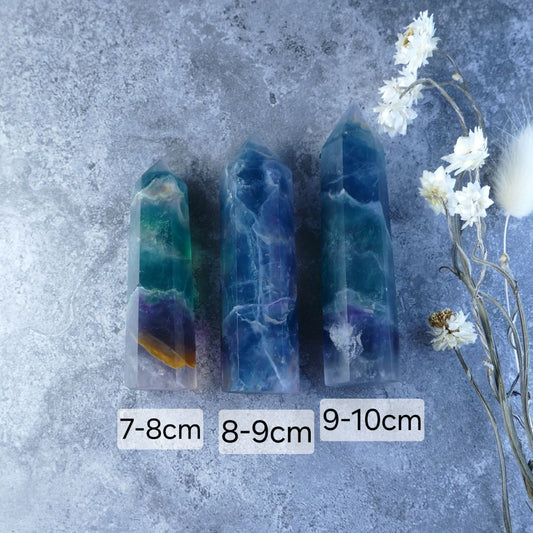 Rainbow Fluorite Tower - Mesmerizing tower featuring vibrant layers of green, blue, purple, and more. Promotes mental clarity, focus, and positive energy.