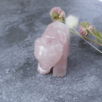 Cuddle up with tranquility! This 2-inch rose quartz bear carving promotes love and emotional well-being.  