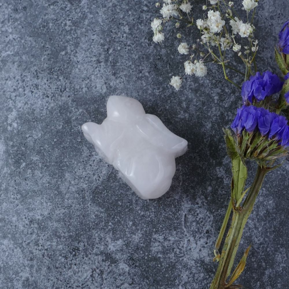 Dumi's Crystals | Rose Quartz Bunny Carving (Heart's Embrace): A Rose Quartz Crystal Bunny Carving, crafted from delicate light pink, almost white stone. This symbol of love & compassion invites you to open your heart and embrace emotional healing. Find love within with Dumi's Crystals (ethically sourced).