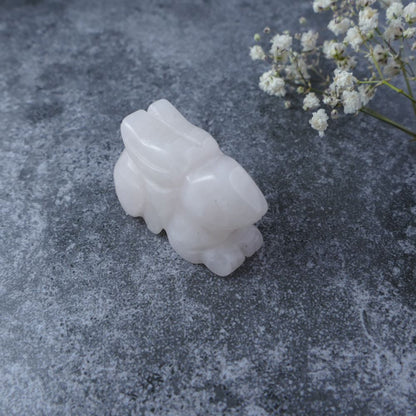 Dumi's Crystals | Rose Quartz Bunny Carving (Love's Light):  An adorable Rose Quartz Crystal Bunny Carving, bathed in the gentle light of love. Rose Quartz, known as the "Stone of Love," fosters compassion & deepens connections. Let this bunny guide you on a journey of self-discovery & love. Ethically sourced crystals from Dumi's Crystals.