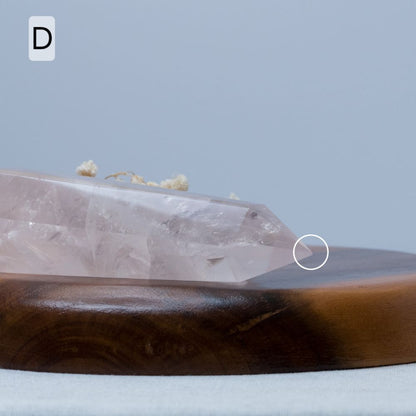 Crystal on a wooden plate with a gray background