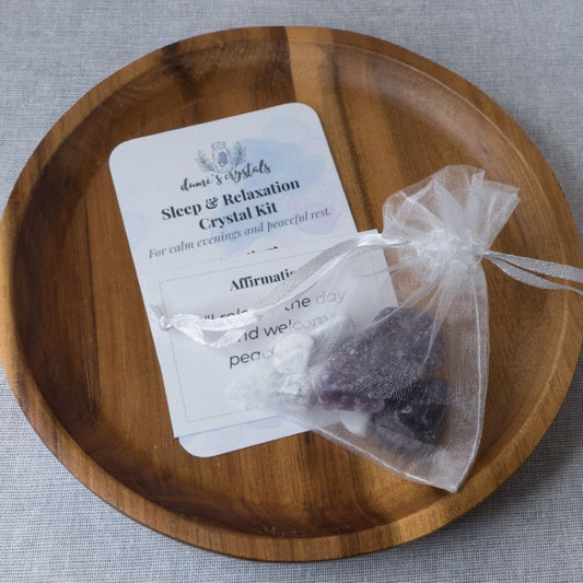 Sleep and relaxation crystal kit with stones and card on a wooden plate