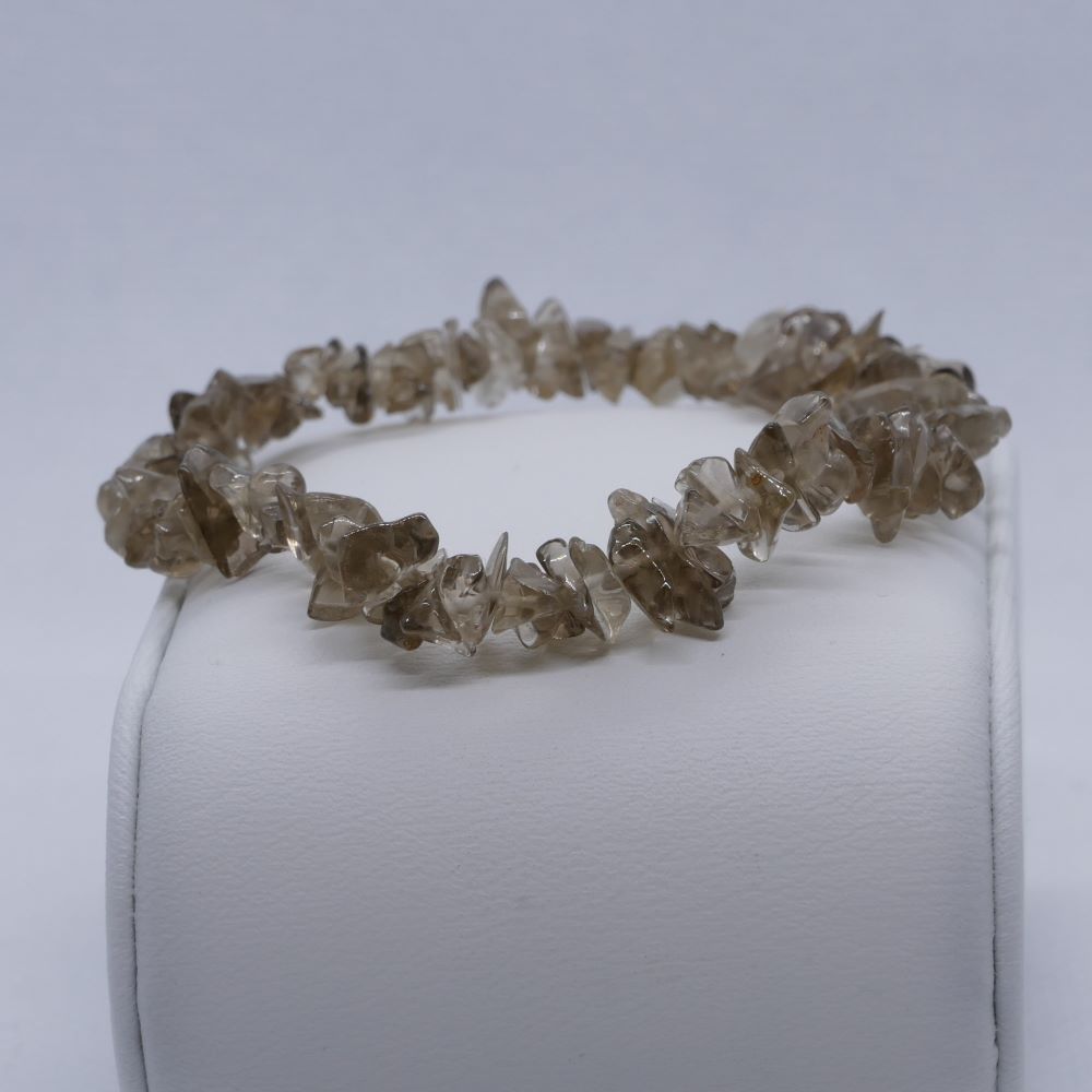  Dumi's Crystals | Smoky Quartz Chip Stretch Bracelet (7 Inch) | Close-up of a handcrafted bracelet featuring genuine Smoky Quartz chips in varying shades of smoky gray and brown. Smoky Quartz is known as the grounding stone and is believed to promote emotional healing, protection from negativity, and mental clarity.