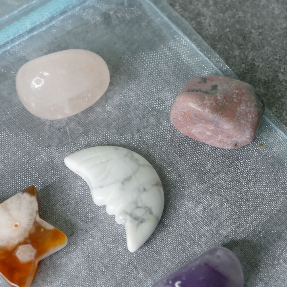 Four different stones on a textured gray surface