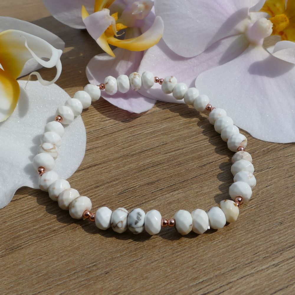 image of a bracelet made with white magnesite rondelles and rose gold beads. this bracelet is available at dumi's crystals