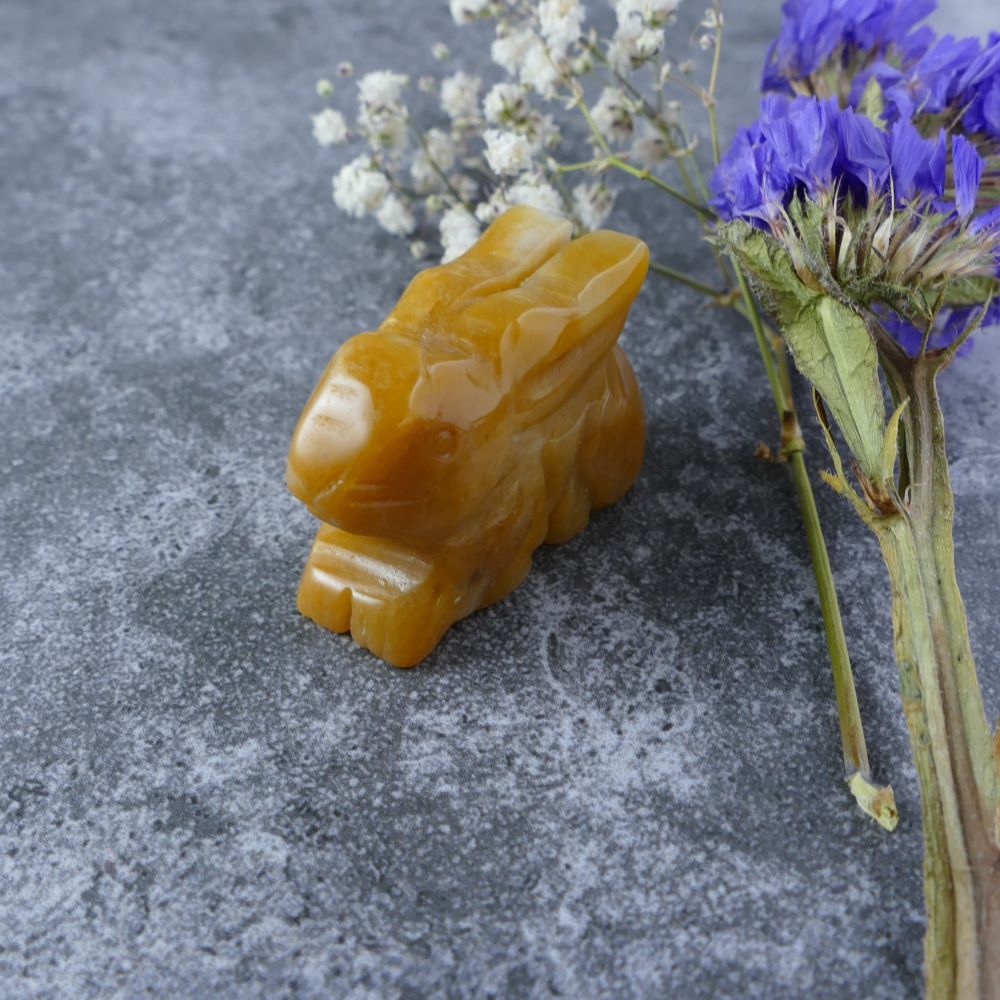 Dumi's Crystals | Yellow Aventurine Bunny Carving (Spark of Adventure):  An adorable Yellow Aventurine Crystal Bunny Carving, ready for an adventure. Yellow Aventurine ignites curiosity & a sense of adventure. Let this bunny guide you on a journey filled with joy. Ethically sourced crystals from Dumi's Crystals.