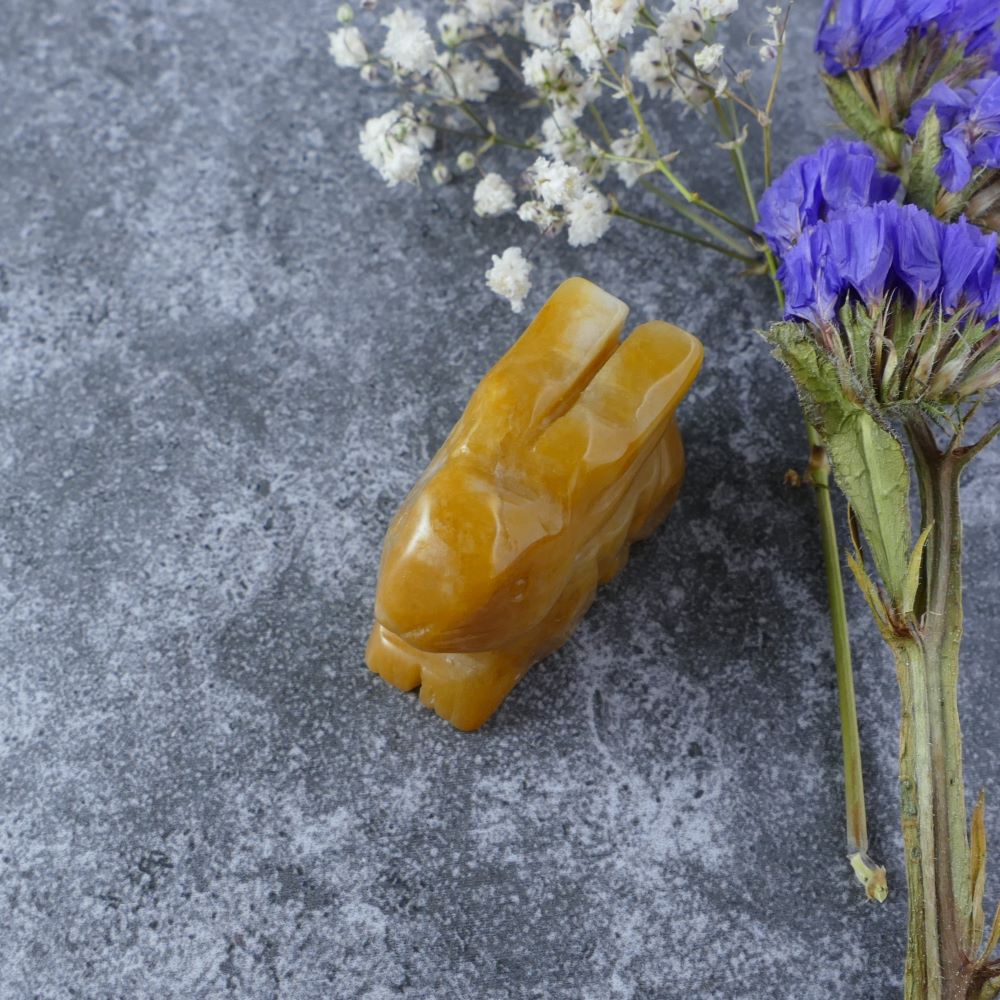 Dumi's Crystals | Yellow Aventurine Bunny Carving (Confident Strides):  A Yellow Aventurine Crystal Bunny Carving, full of confidence. Yellow Aventurine, the "Stone of Opportunity," promotes self-belief & motivation. This bunny encourages you to pursue your dreams with a fearless heart. Ethically sourced crystals from Dumi's Crystals.