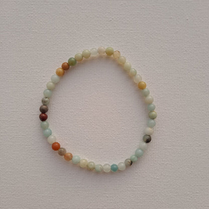 Dumi's Crystals Amazonite Stretch Bracelet. This beautiful bracelet features genuine 4mm round Amazonite beads, meticulously handcrafted and strung on durable stretch fiber for a comfortable fit. Perfect for those seeking the calming energy of Amazonite to promote balance, harmony, and well-being.