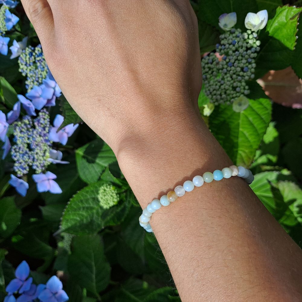 Dumi's Crystals Amazonite Stretch Bracelet. This beautiful bracelet features genuine 4mm round Amazonite beads, meticulously handcrafted and strung on durable stretch fiber for a comfortable fit. Perfect for those seeking the calming energy of Amazonite to promote balance, harmony, and well-being.