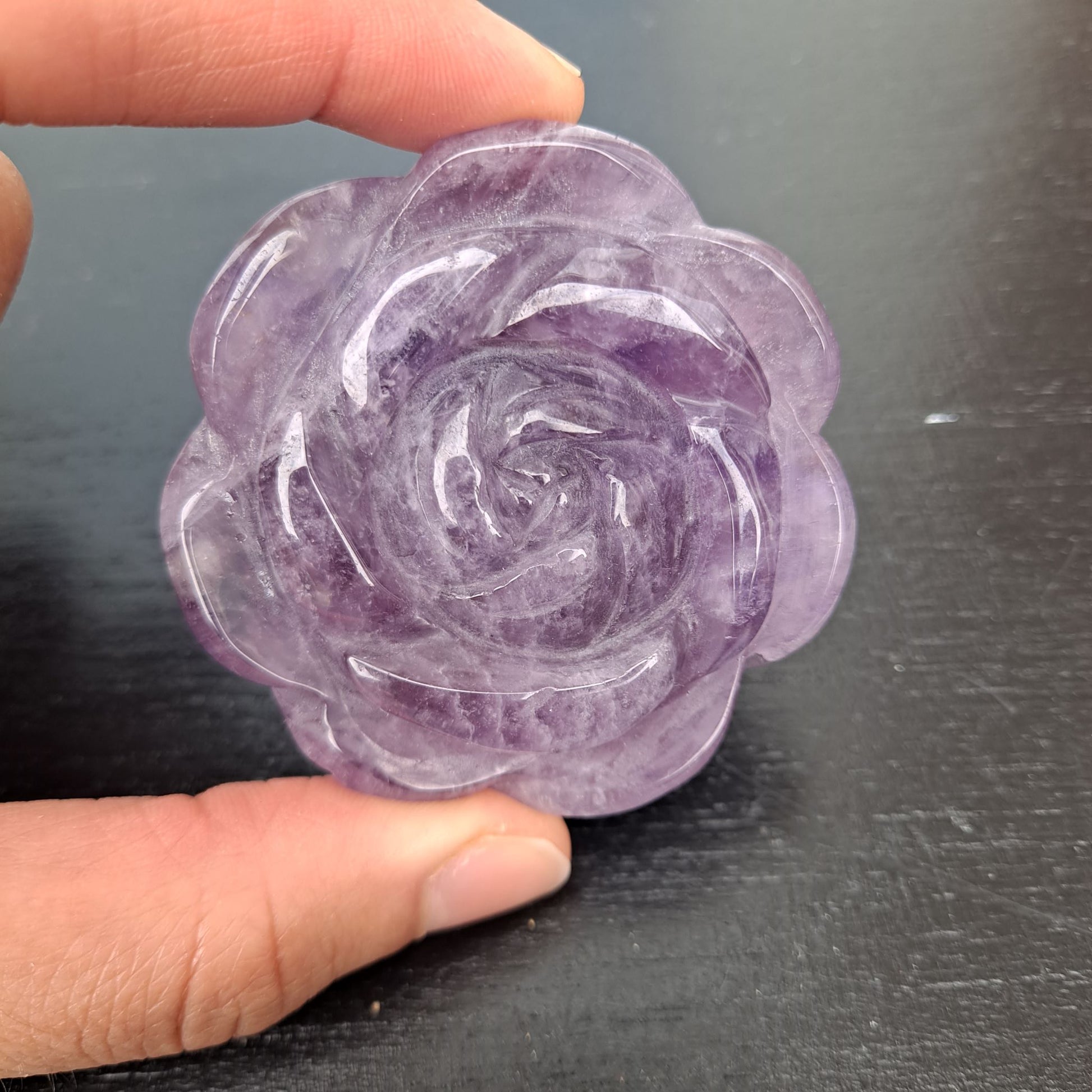 Dumi's Crystals | Amethyst Rose Carving (Shimmering Serenity) | Witness the captivating play of light on an Amethyst Rose Carving. Hand-carved from Amethyst, February's birthstone, this exquisite piece radiates serenity & promotes inner peace. Dumi's Crystals - Ethically sourced crystals for your spiritual journey.