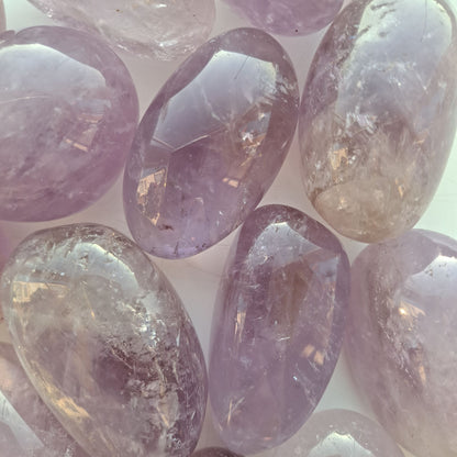 Dumi's Crystals | Amethyst Tumbled Stones (Sparkling Serenity) | A collection of Amethyst Tumbled Stones, each a unique masterpiece in shades of deep purple. Amethyst is renowned for its calming energy and spiritual properties. Scatter them in your home or workspace to create a peaceful and uplifting atmosphere.