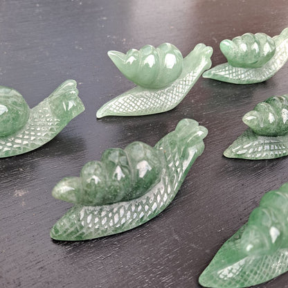 Dumi's Crystals | Green Aventurine Snail Carving (Serene Guidance):  A close-up of a Green Aventurine Snail Carving, showcasing its intricate details and mesmerizing green hues. Hand-carved from Green Aventurine, this symbol of patience & steady progress radiates serene guidance. Embrace calmness & abundance with Dumi's Crystals (ethically sourced).
