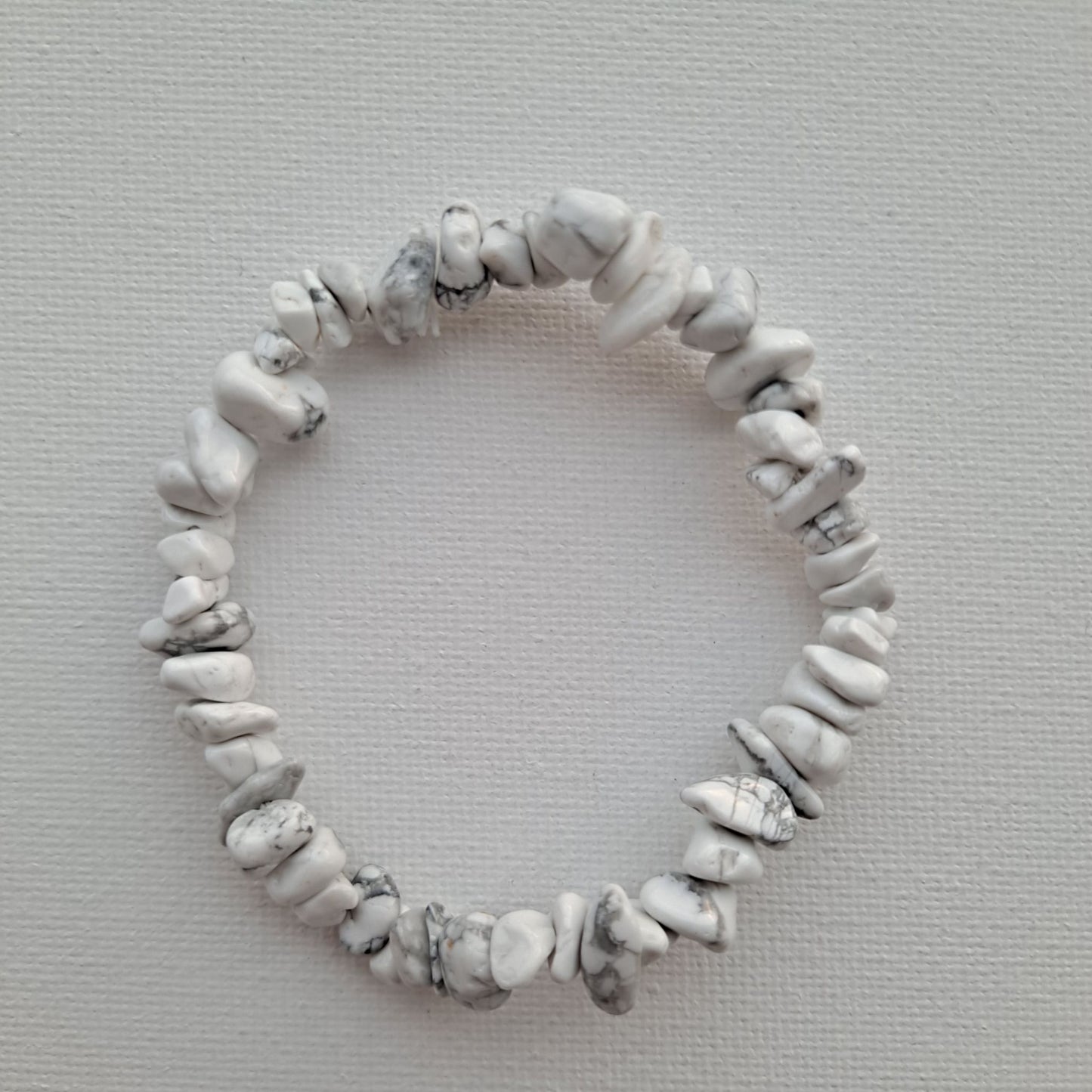 Dumi's Crystals | Howlite Chip Stretch Bracelet (7 Inch) | Close-up of a handcrafted bracelet featuring genuine Howlite chips. The calming white chips create a unique texture and cascade of color. Howlite, often called the "stone of calmness," is believed to promote stress relief, mental clarity, and emotional balance.