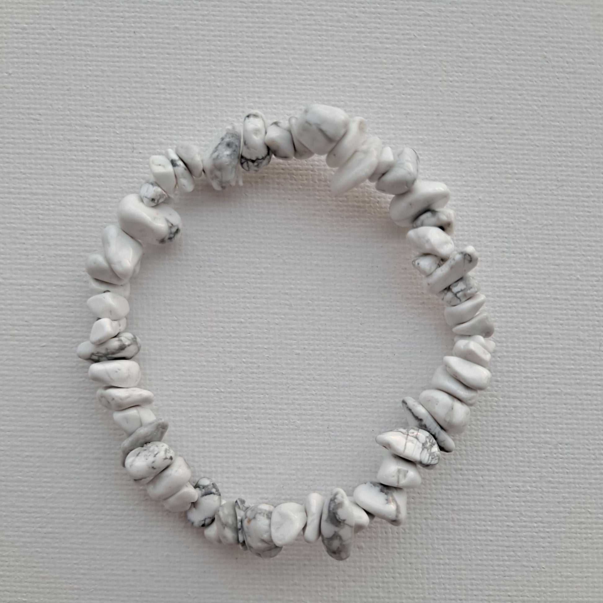 Dumi's Crystals | Howlite Chip Stretch Bracelet (7 Inch) | Close-up of a handcrafted bracelet featuring genuine Howlite chips. The calming white chips create a unique texture and cascade of color. Howlite, often called the "stone of calmness," is believed to promote stress relief, mental clarity, and emotional balance.