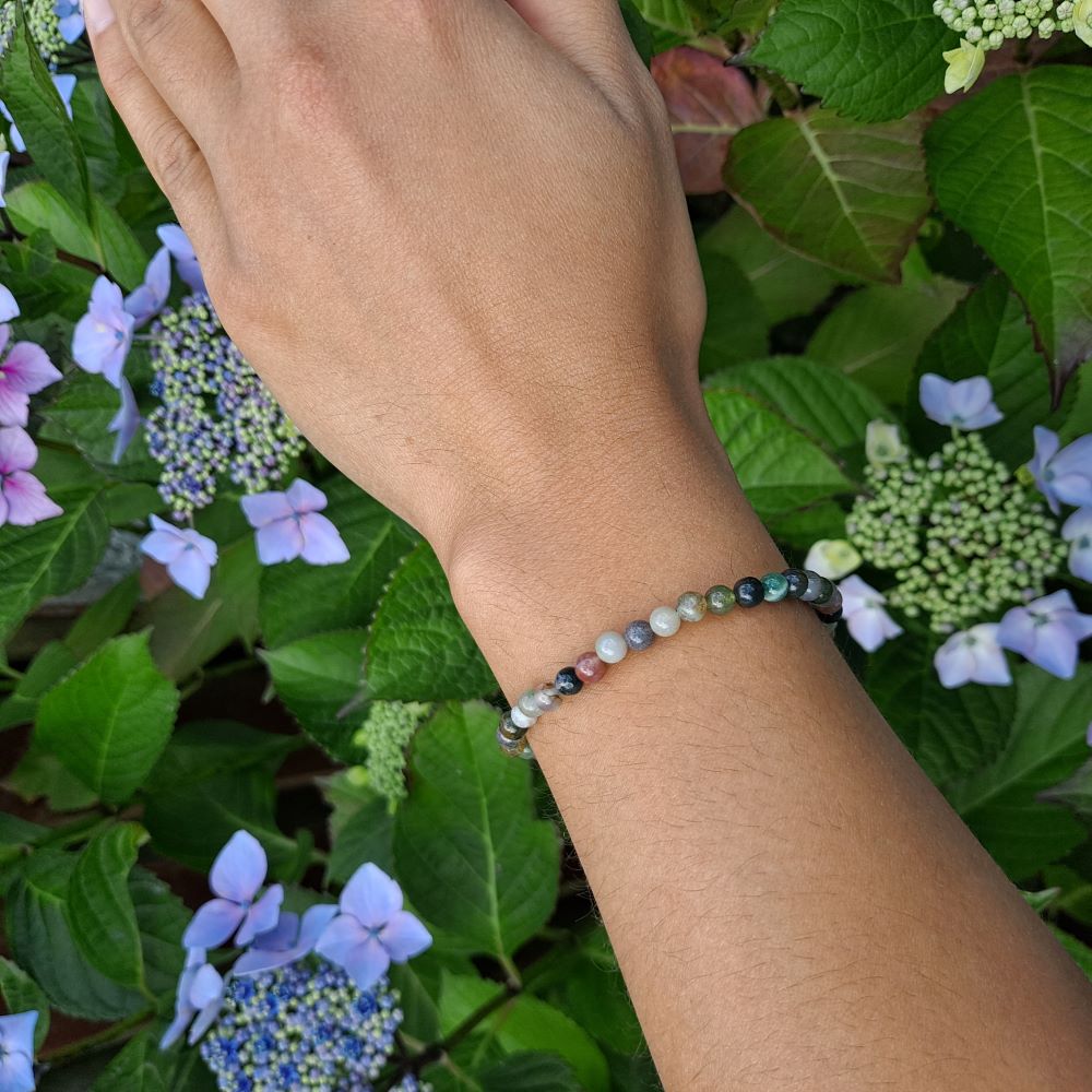 Dumi's Crystals | Indian Agate Stretch Bracelet (4mm) | Showcasing the captivating beauty of Indian Agate on a wrist. This bracelet features a variety of colors and swirling patterns, known as the "Earth Rainbow Stone." Indian Agate promotes stability, balance, and inner peace.