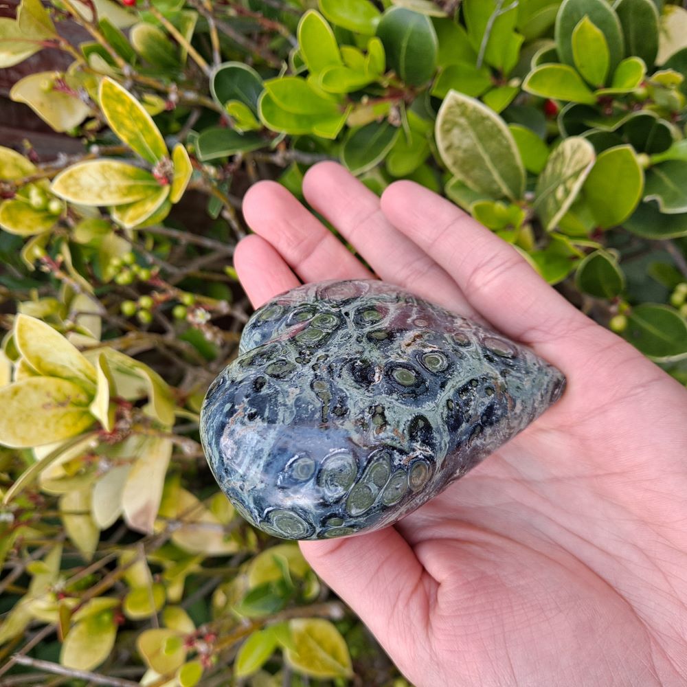 Dumi's Crystals | Unique Kambaba Jasper Heart Carving (Nature's Embrace): Immerse yourself in the grounding energy of a unique Kambaba Jasper Heart Carving. Hand-crafted to showcase natural beauty, this one-of-a-kind heart fosters emotional well-being, spiritual growth & a profound earth connection. Dumi's Crystals - Ethically sourced crystals for your journey.