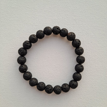Dumi's Crystals | Lava Stone Stretch Bracelet (8mm) | Close-up of a handcrafted bracelet featuring genuine 8mm Lava Stone beads. Known for their grounding energy, these porous volcanic rock beads can also be used to diffuse your favourite essential oils.