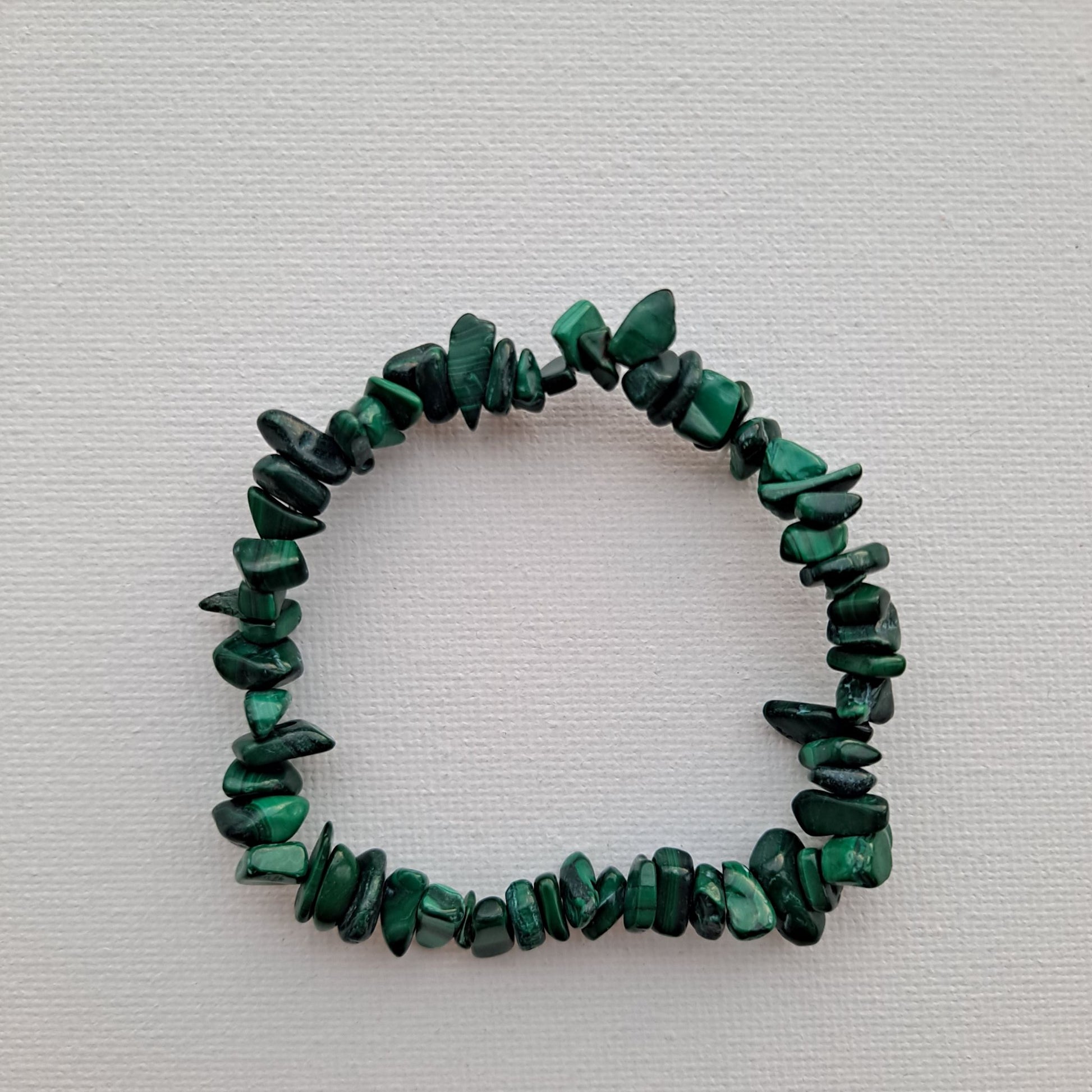 7-Inch Malachite Bracelet | Dumi's Crystals | Genuine Malachite chips strung on a durable stretch cord. This bracelet is known for its captivating beauty and connection to the heart chakra, promoting emotional well-being.