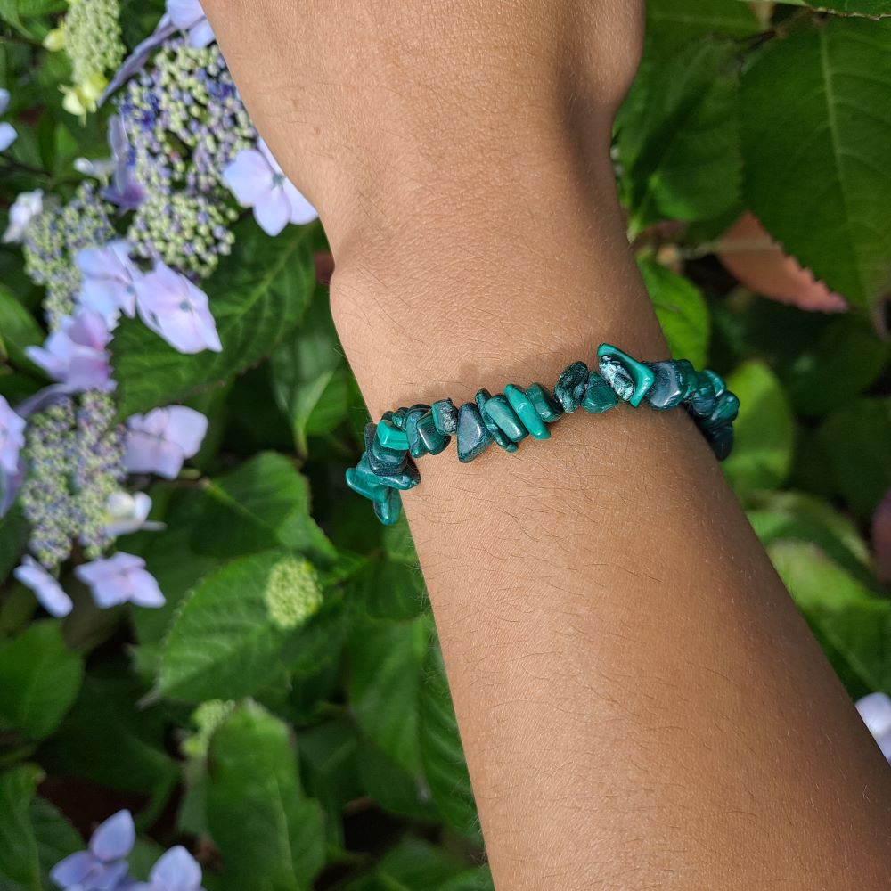 Dumi's Crystals | Malachite Stretch Bracelet | Showcasing the captivating green hues and swirling patterns of Malachite on a wrist. This bracelet is known for its transformative energy, promoting emotional healing, courage, and growth.