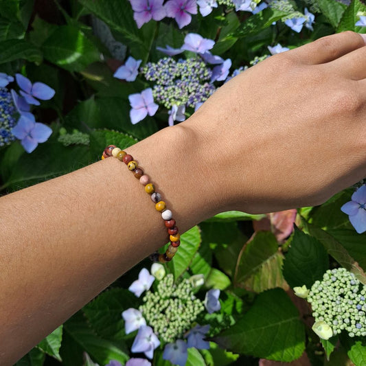 Dumi's Crystals | 4mm Mookaite Jasper Stretch Bracelet | Showcasing the delicate beauty of 4mm Mookaite Jasper beads on a wrist. This bracelet offers grounding energy, emotional balance, and a connection to nature's beauty.